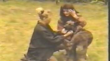 Retro footage featuring women eagerly engaging with the dog's penis