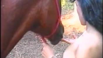 Adorable dark-haired girl 18+ is blowing a massive horse on the ranch