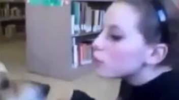 Adorable brunette passionately kissing a dog and getting steamy